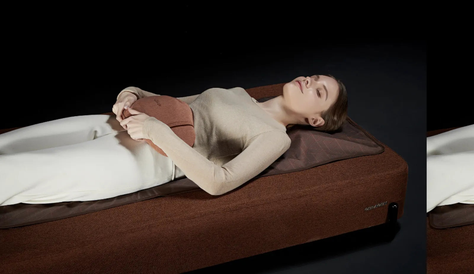 A person lying on the Master S4 against a dark backdrop